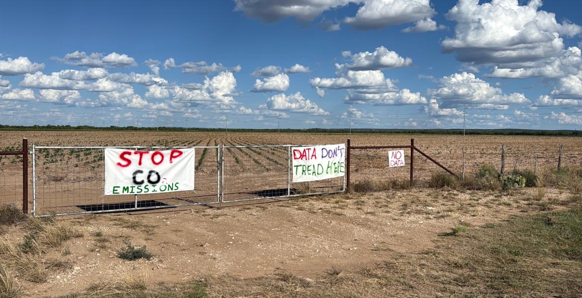 Protest signs near the proposed Beacon Data Centers project site in southwest Tom Green County