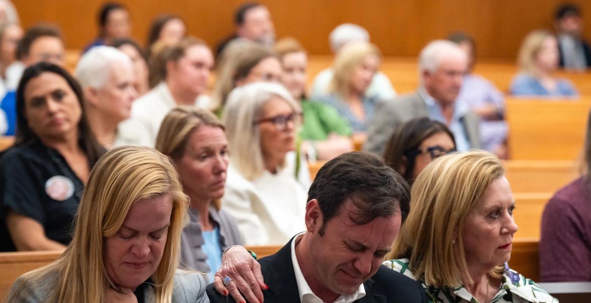 Edward Eastland breaks down in tears as he’s comforted by Tweedy Eastland, right, and Mary Liz Eastland, left, during a hearing on a lawsuit against Camp Mystic in an Austin courtroom on April 14, 2026.