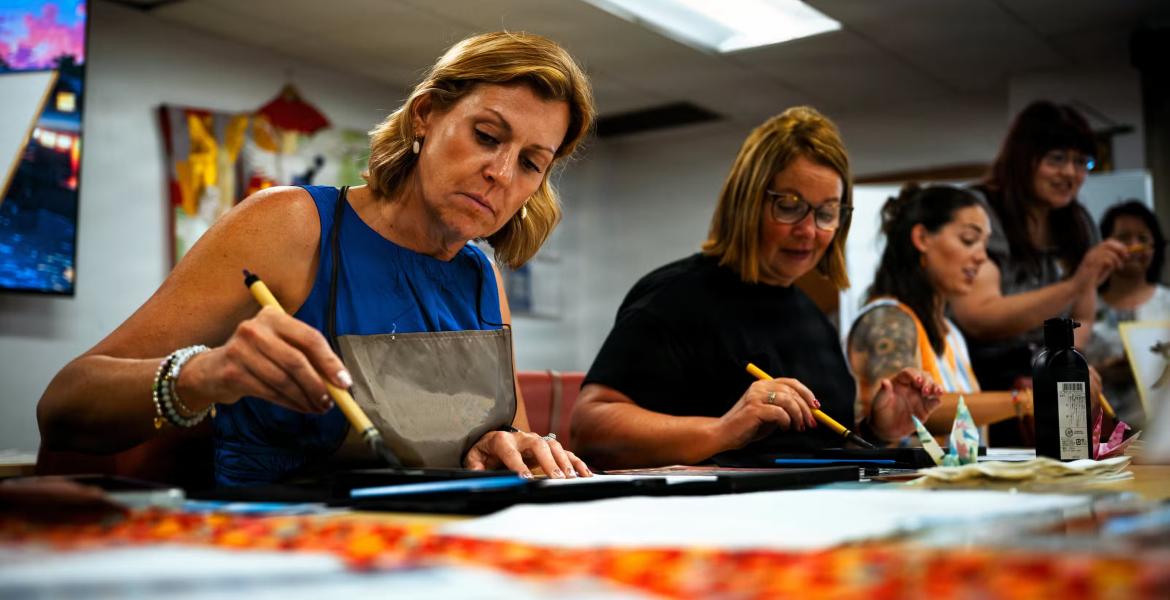 Military spouses learn how to write kanji at the Military and Family Readiness Center at Kadena Air Base, Japan, June 23, 2026. The MFRC connects service members and families with relocation, financial, readiness and support resources throughout their assignment. (Senior Airman Mason Hargrove/U.S. Air Force)