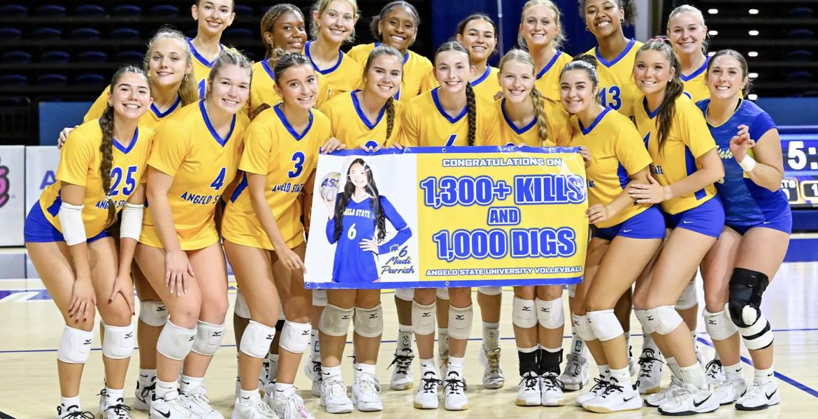 2026 Volleyball Team celebrating Madi Parrish 1,000 digs