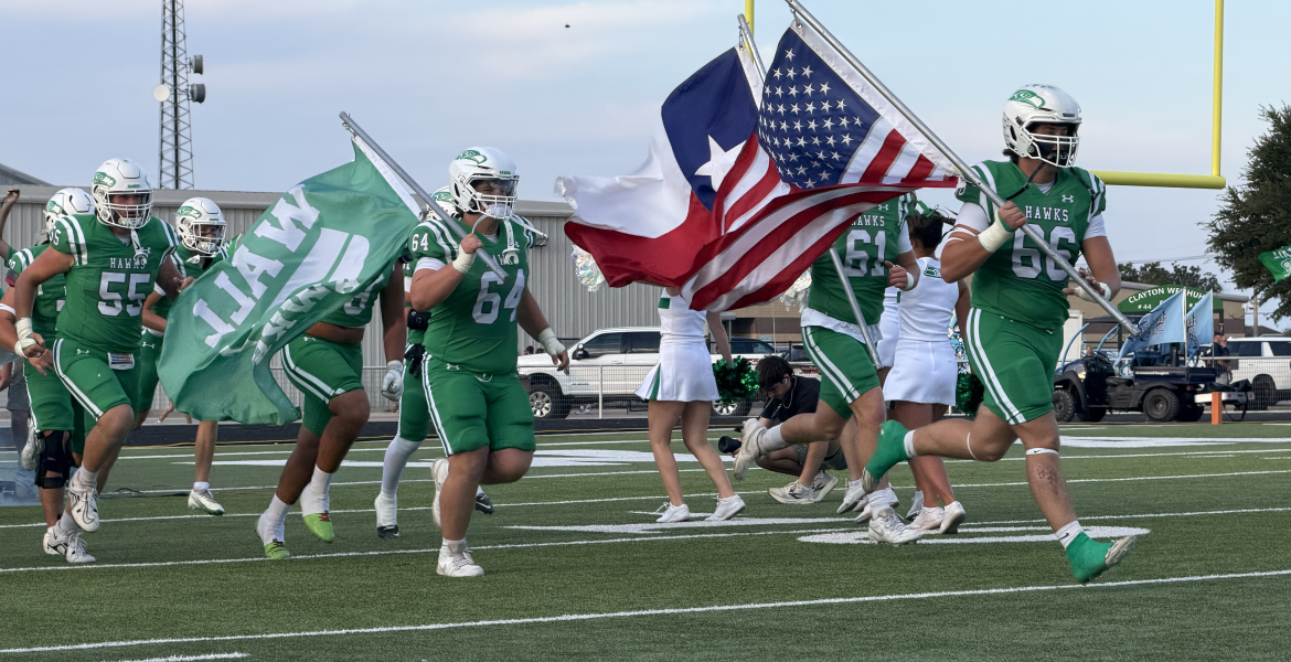 The Wall Hawks run onto the field before their game against Midland Greenwood on Friday, Sept. 25, 2026.