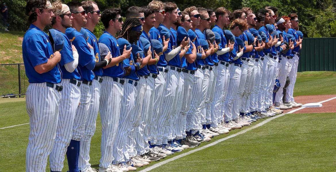The Angelo State baseball team stands before a game during the 2025 season.